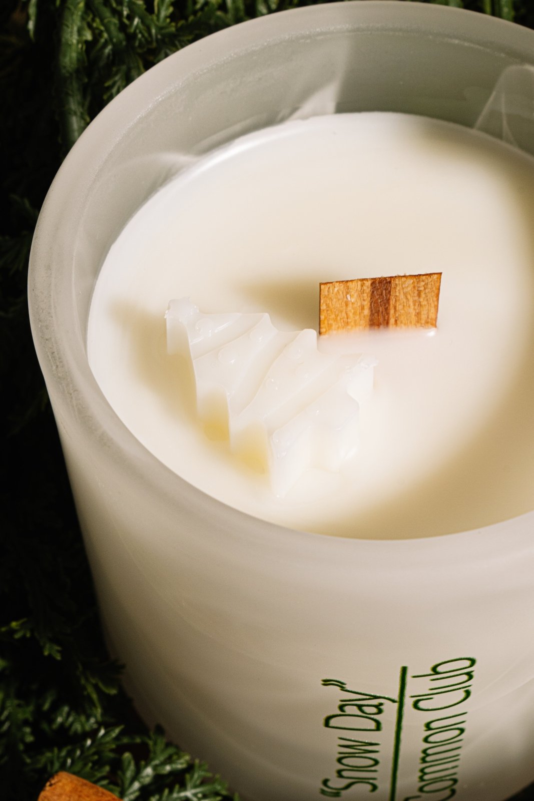 Candle with a wooden wick on a dark background